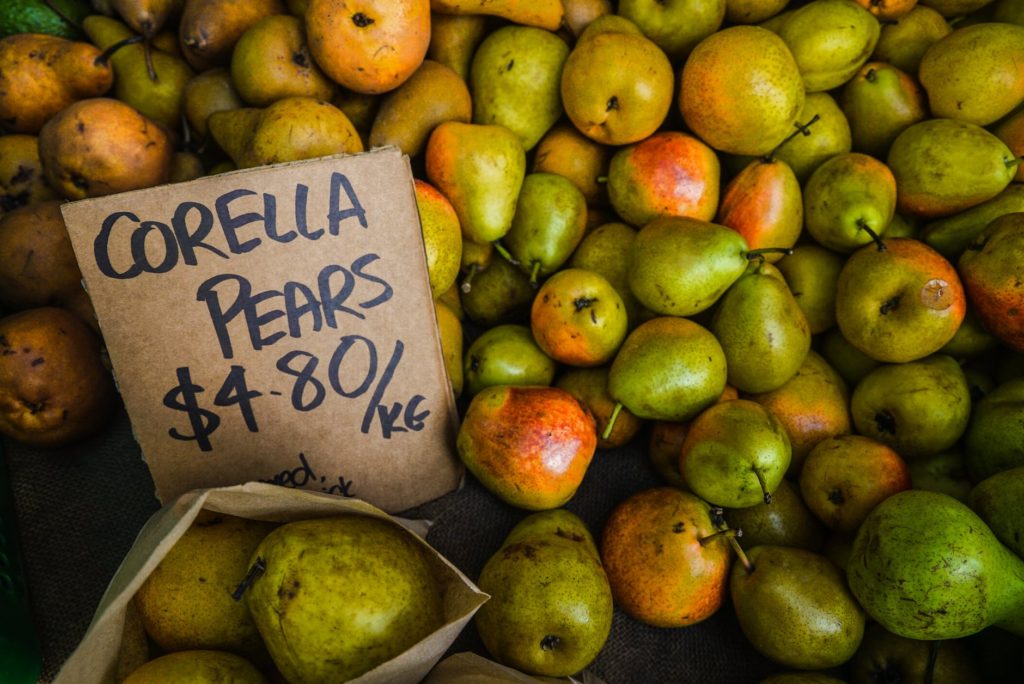 green and orange corella pear fruit lot